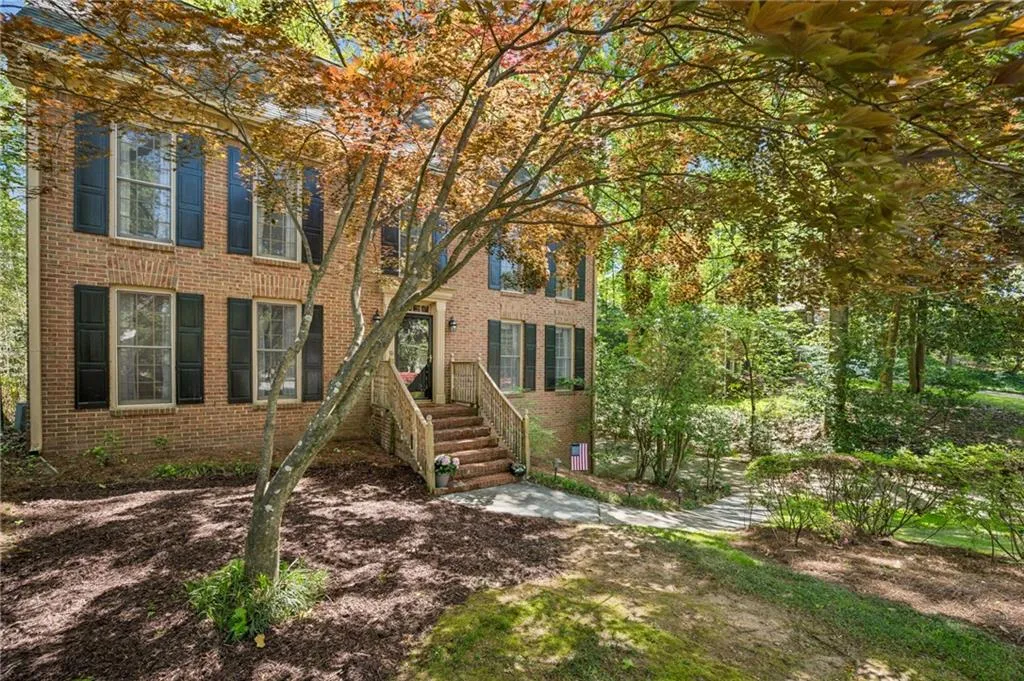Colonial home featuring brick siding.