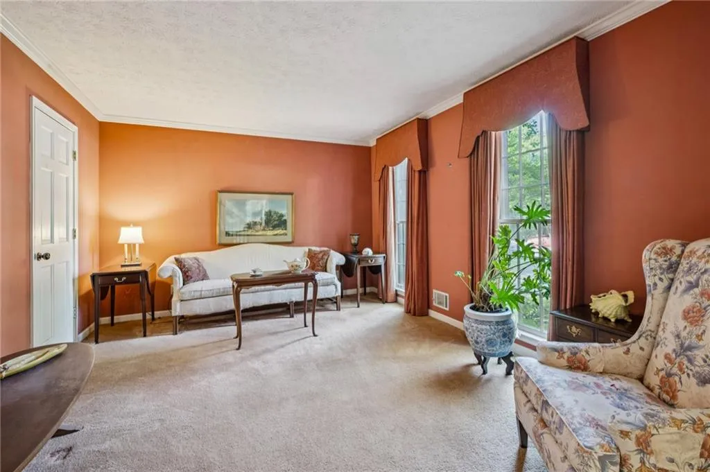 Formal Sitting room with professionally made valances and curtains.