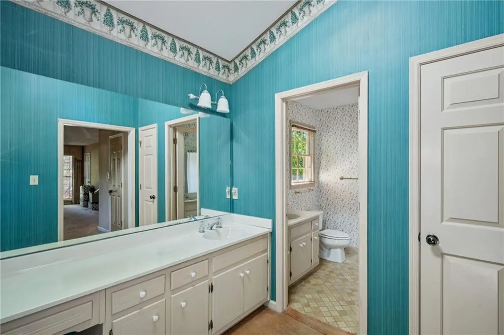 Primary bath with linen closet on right.