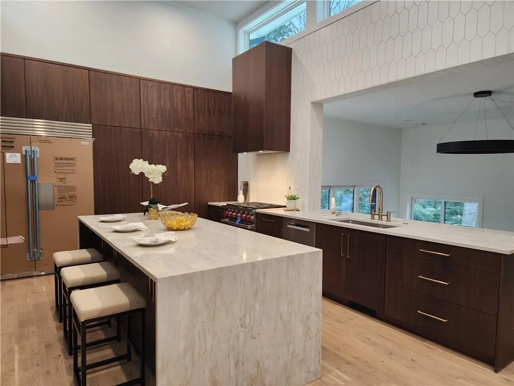 Sub Zero Fridge, Waterfall quartz tops, 6 Burner Wolf gas range, microwave drawer in island, Bosch 800 series dishwasher