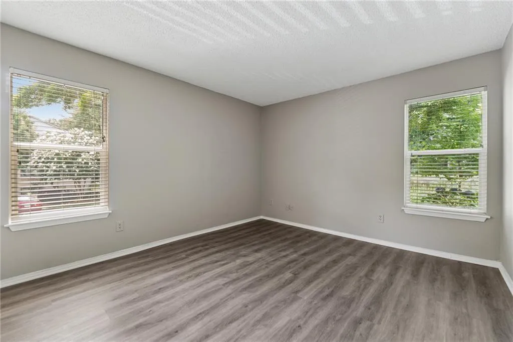 Unfurnished room with wood finished floors and a textured ceiling