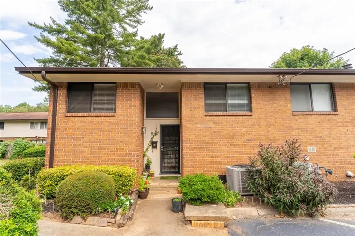 Brick exterior with an integrated entryway and front door with security screen