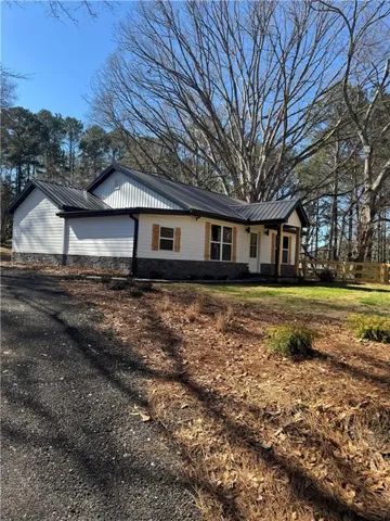 White siding exterior with a dark metal roof