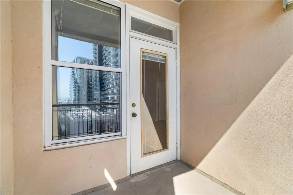 Doorway to property with stucco siding and a view of city