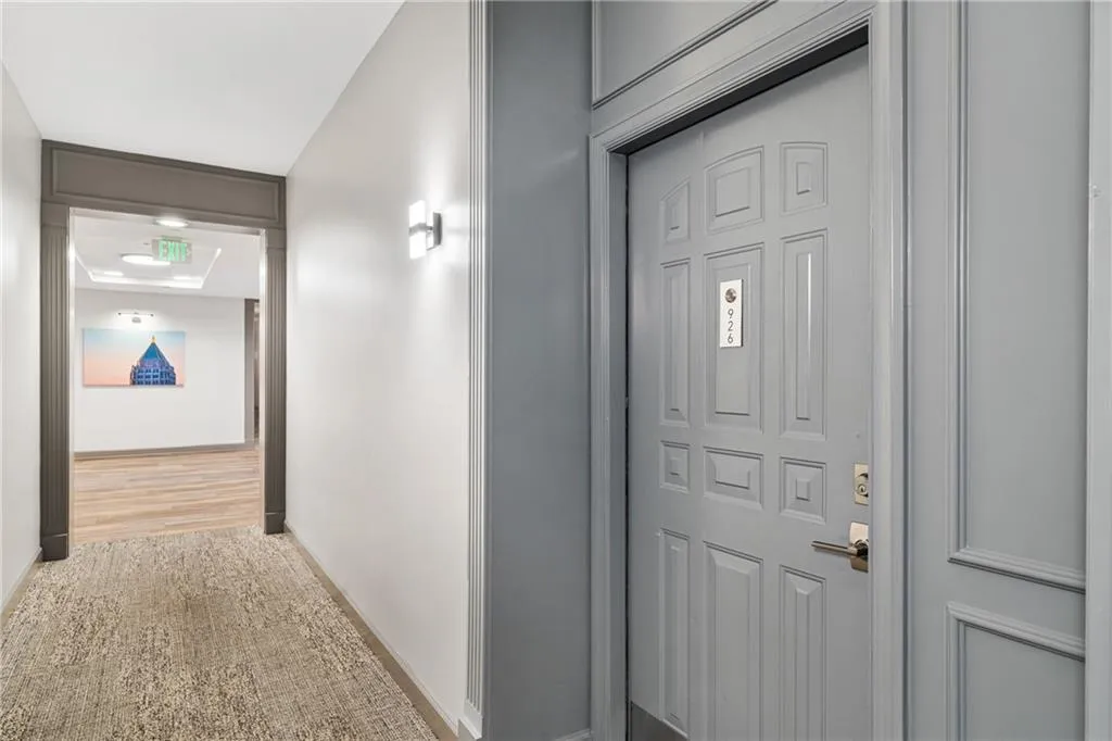 Corridor with baseboards and carpet