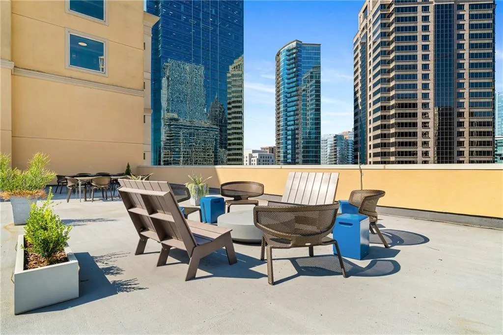 View of patio with a city view and an outdoor fire pit