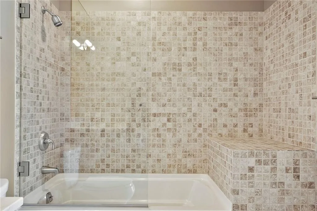 Full bathroom with combined bath / shower with glass door