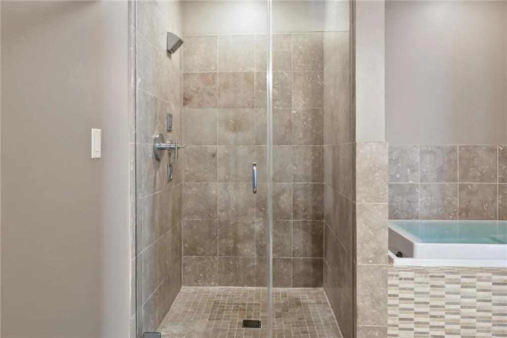 Bathroom featuring a shower stall and a garden tub