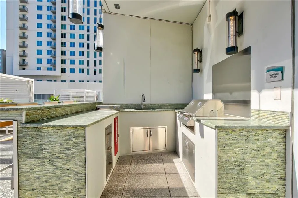 View of patio / terrace with an outdoor kitchen and a sink