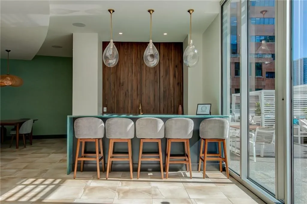 Club Room Indoor wet bar with pendant lighting and recessed lighting