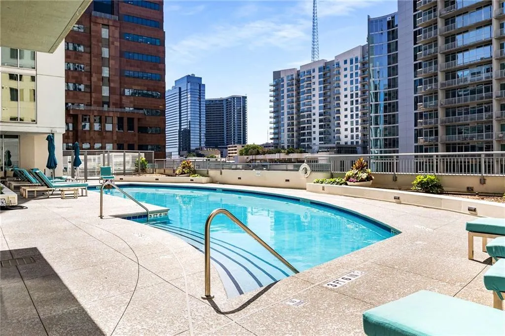 Community pool with a city view and a patio