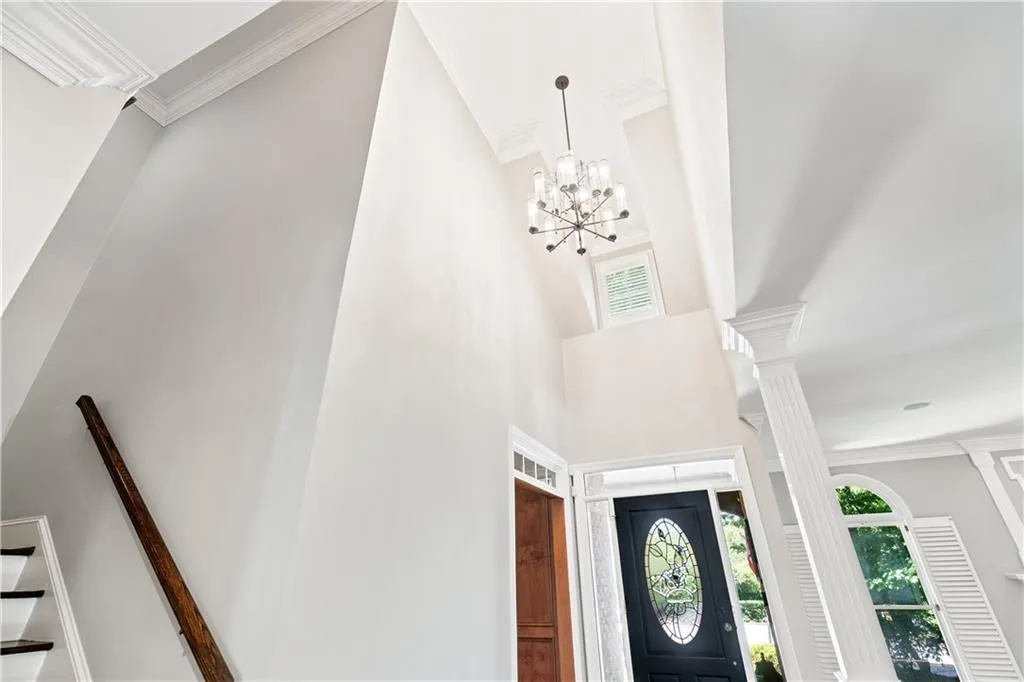 Foyer entrance with an inviting chandelier and towering ceiling