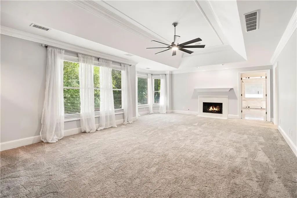 Features ceiling fan, fireplace and sitting area