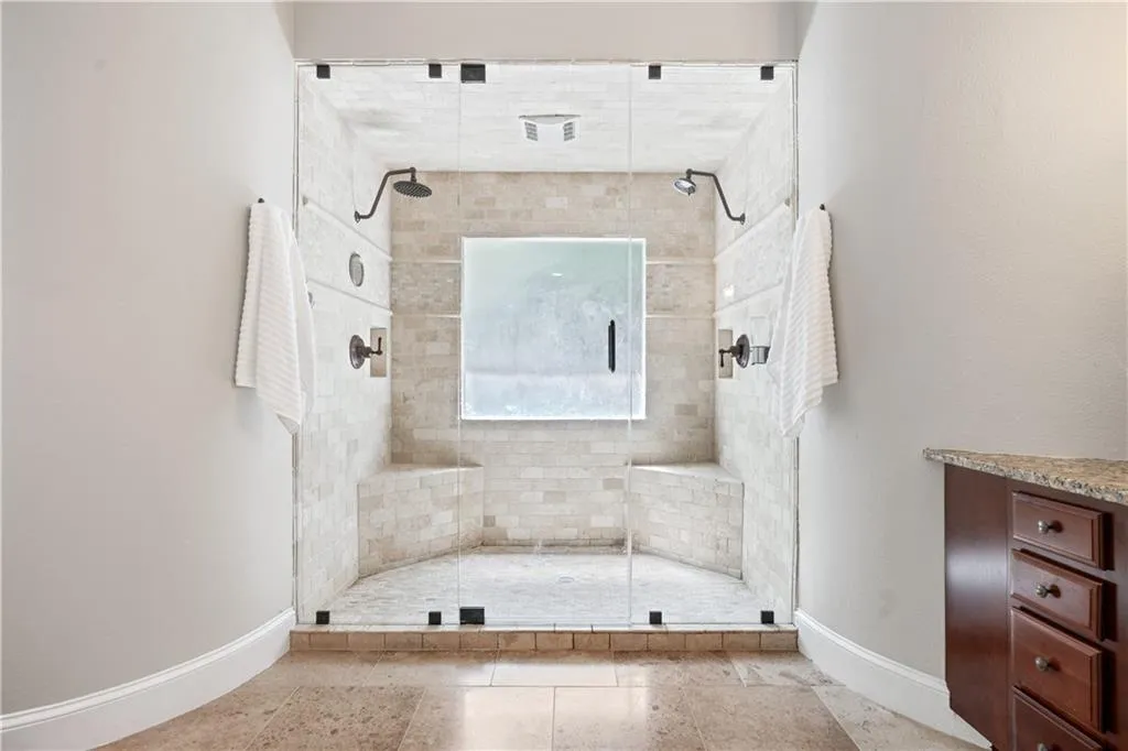 Bathroom with walk in shower and tile patterned flooring
