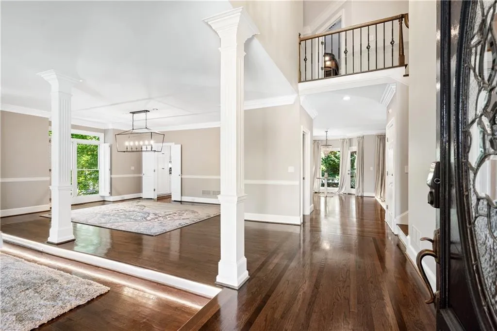 Entrance foyer featuring  hardwood flooring and crown molding