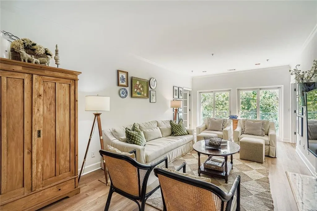 Living area featuring light wood-type flooring and ornamental molding
