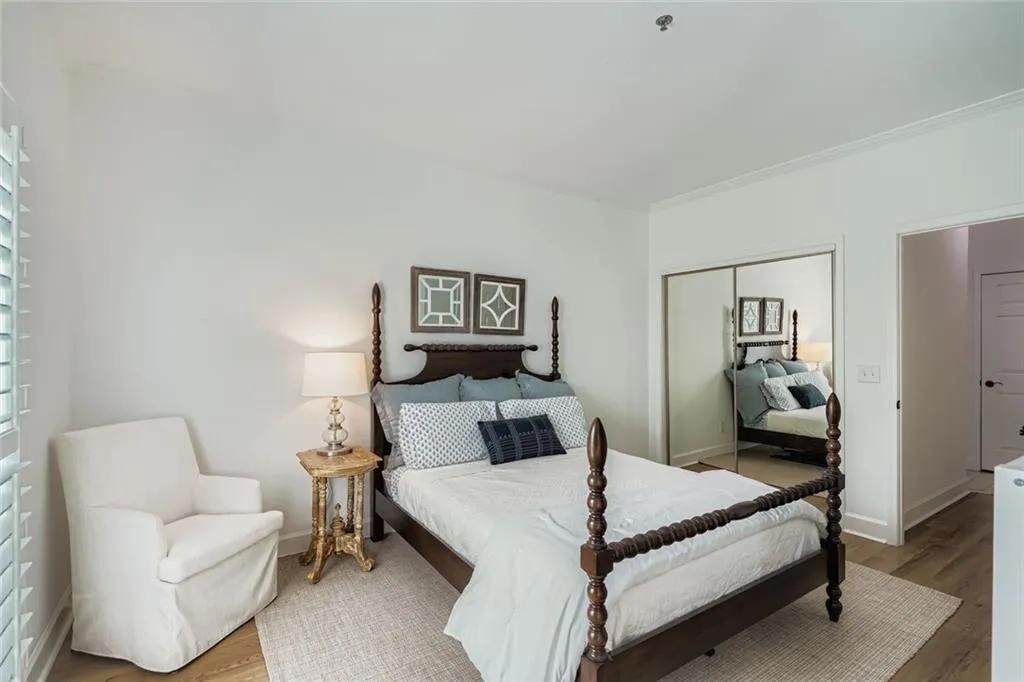 Bedroom featuring wood finished floors and a closet