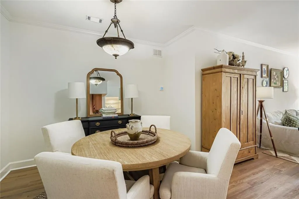 Dining space featuring crown molding and wood finished floors