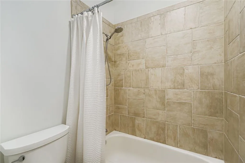 Full bath with shower / tub combo and toilet