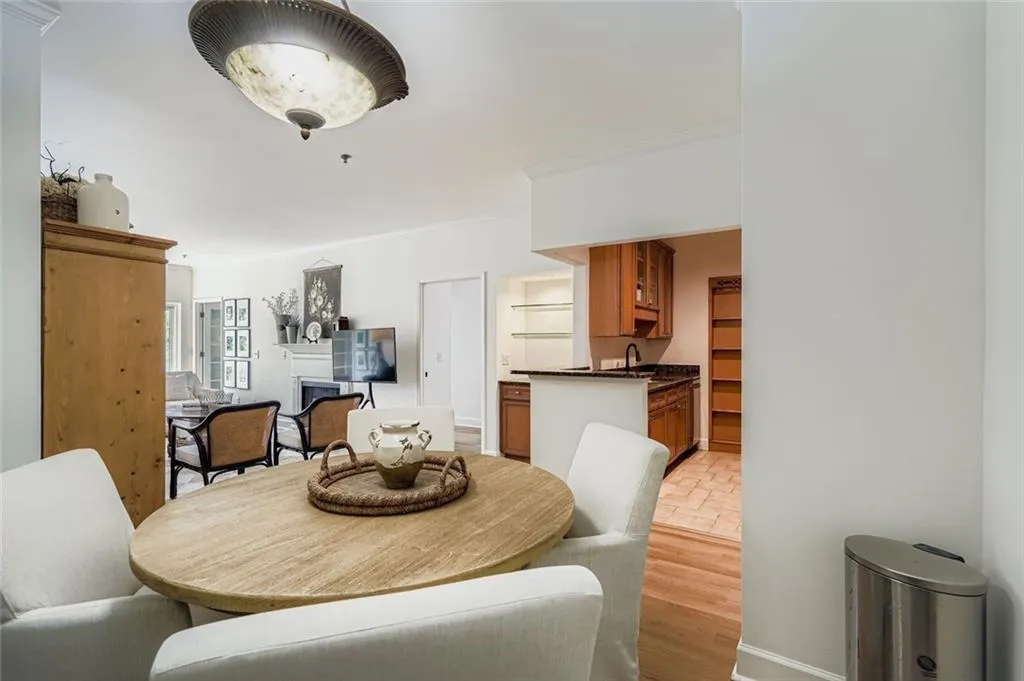 Dining room with light wood-type flooring and crown molding