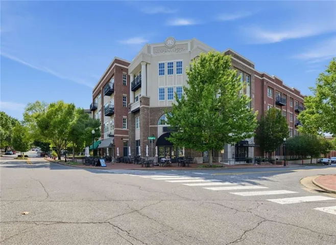 Mixed-use building featuring brick and stone cladding with multiple balconies