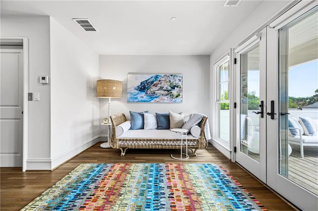 Interior room featuring wood-finish flooring, white baseboards, and a neutral wall color
