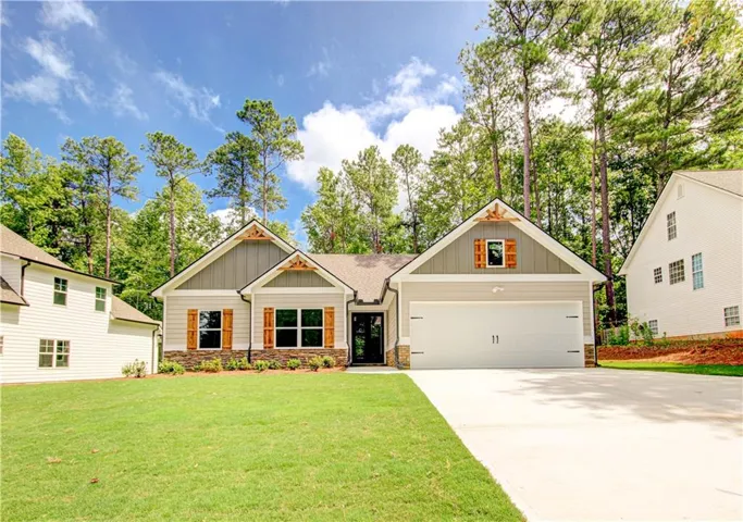 Craftsman-style exterior featuring a prominent two-car garage