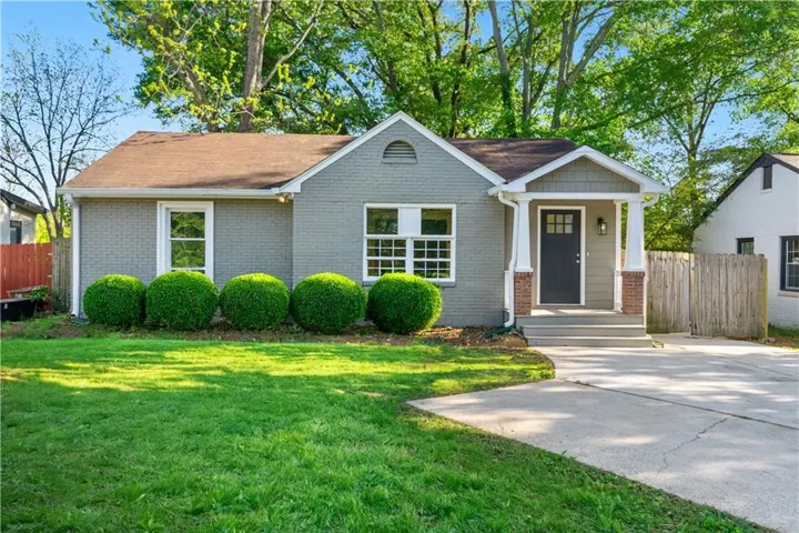 View of front of house with covered porch and brick siding