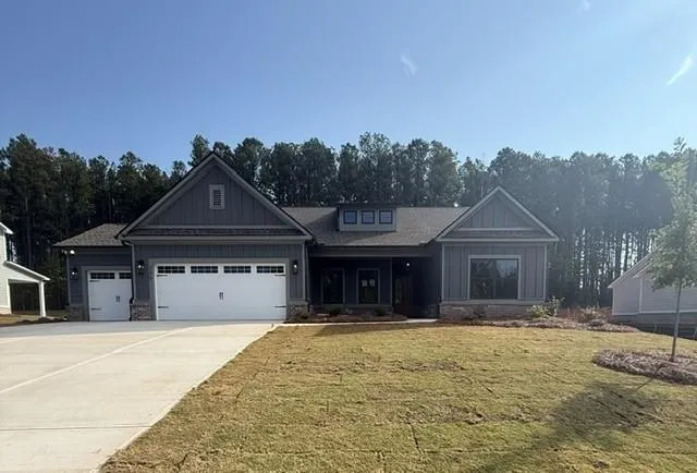 Contemporary ranch-style residence featuring a combination of horizontal siding and vertical board and batten