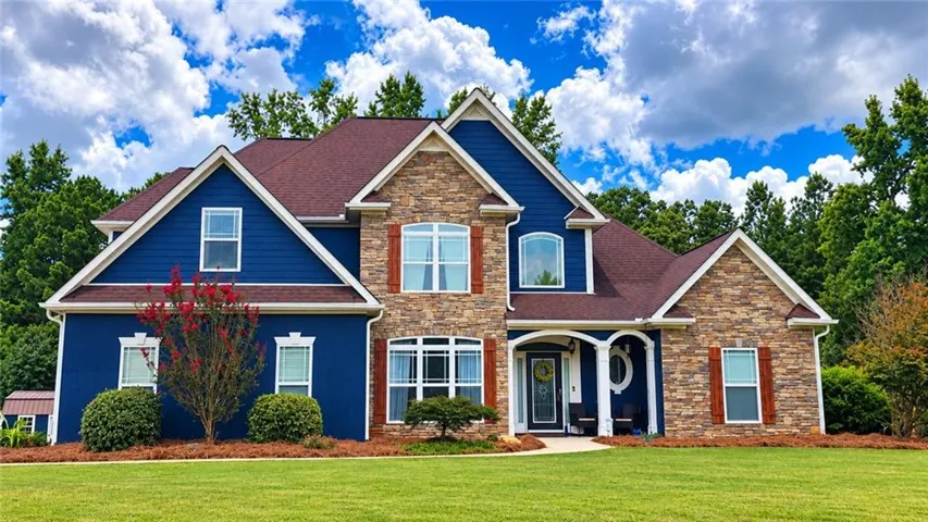 Expansive front lawn with mature landscaping
