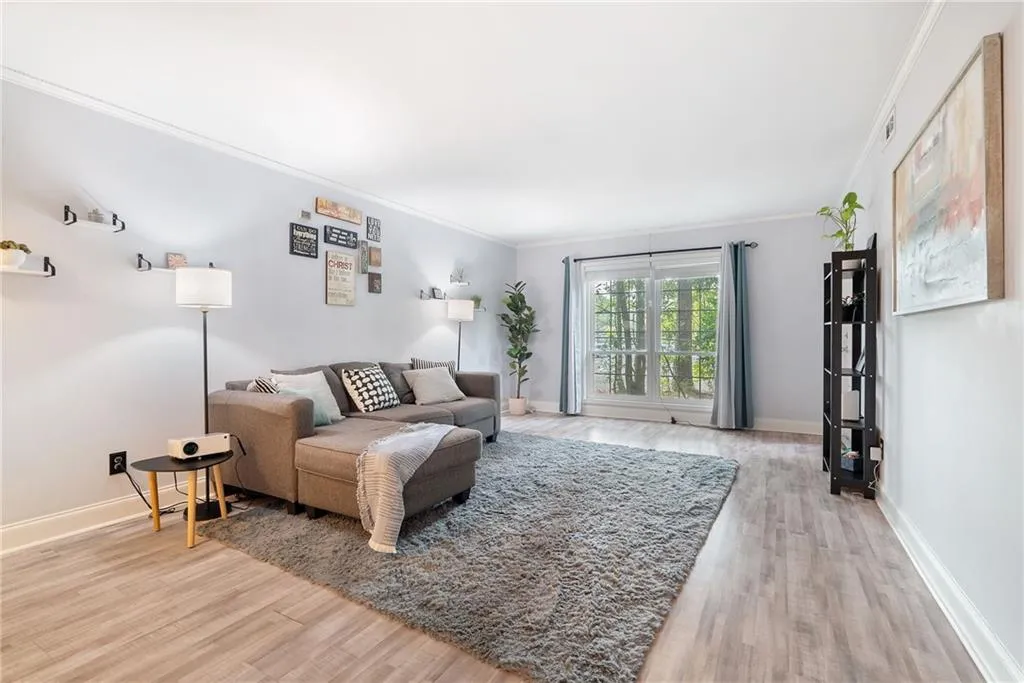 Living room featuring crown molding and wood-type flooring