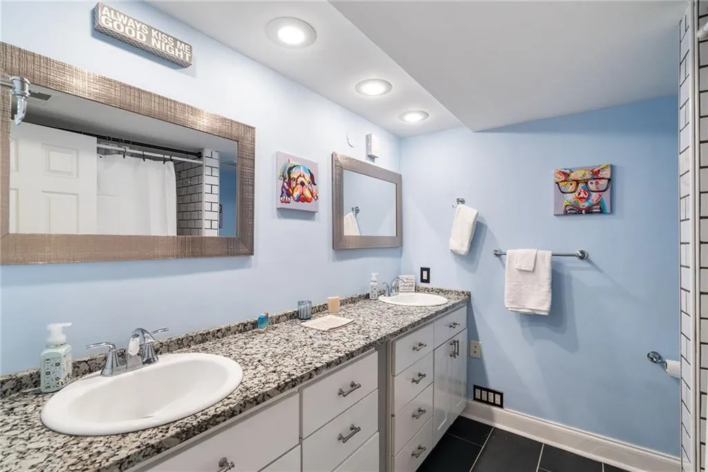 Bathroom with tile patterned floors and vanity