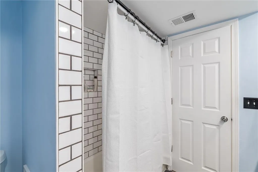 Bathroom featuring shower / tub combo with curtain