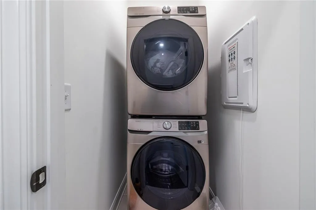 Laundry room featuring stacked washer / dryer
