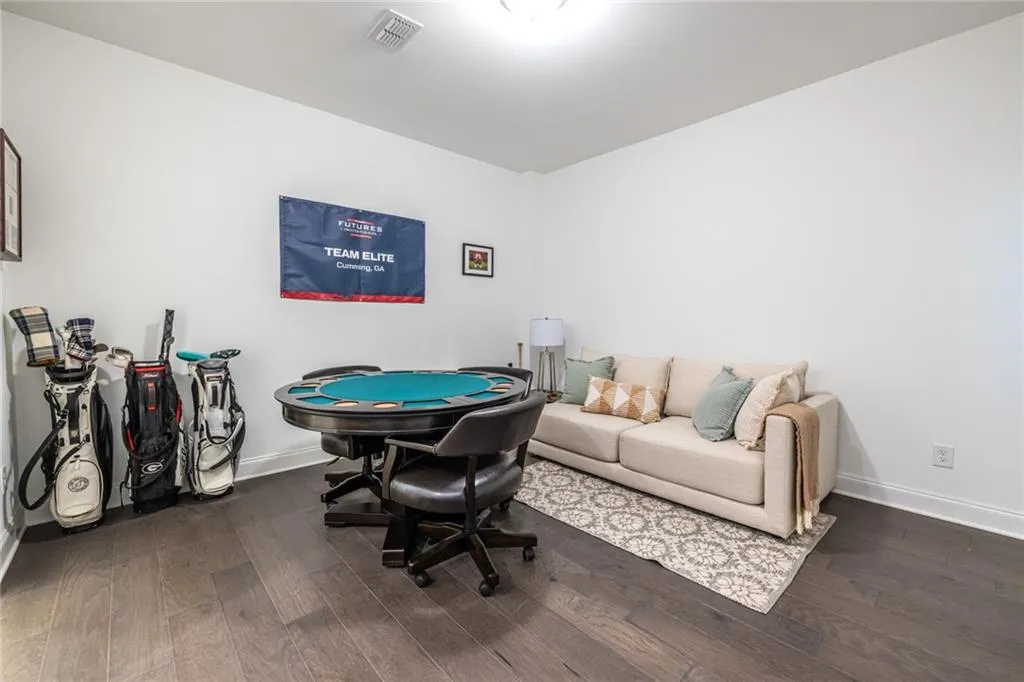 Playroom with wood finished floors and baseboards