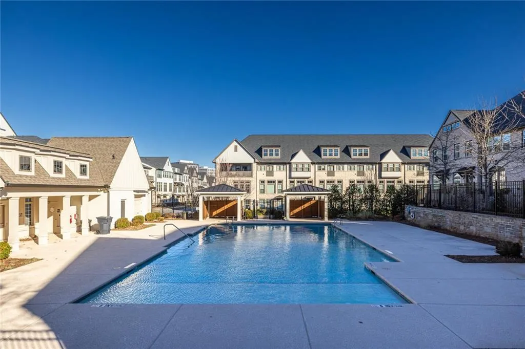 Community pool with a gazebo, a residential view, and a patio area
