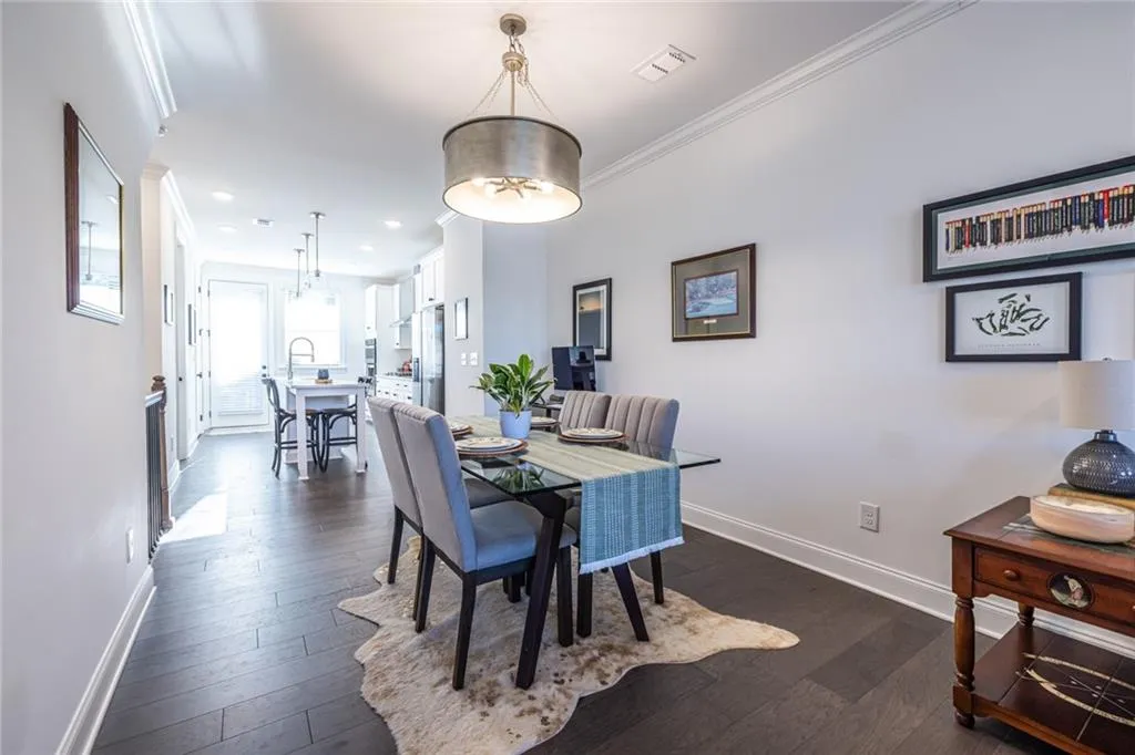 Dining area featuring crown molding, dark wood finished floors, and recessed lighting