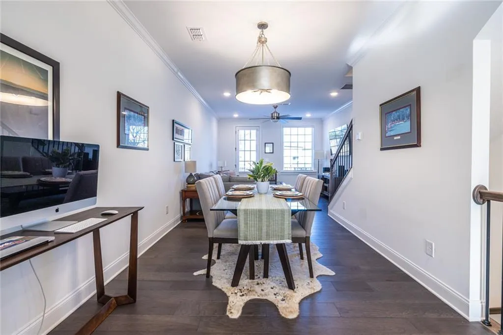 Dining space featuring ornamental molding, a ceiling fan, dark wood-type flooring, stairs, and recessed lighting