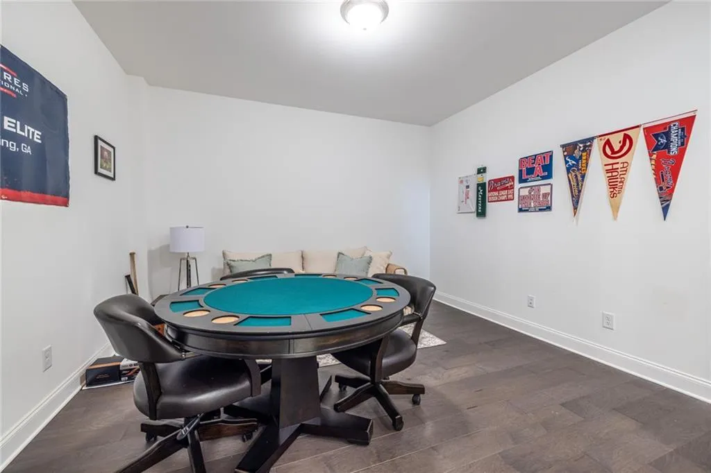 Rec room featuring baseboards and wood finished floors