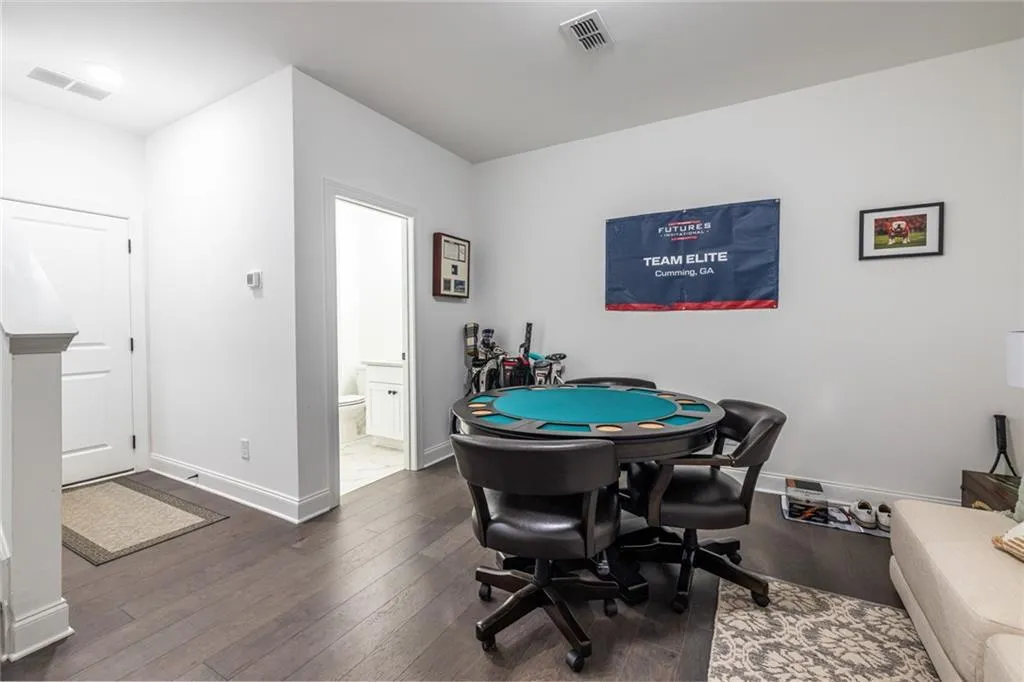 Rec room with hardwood / wood-style floors and baseboards