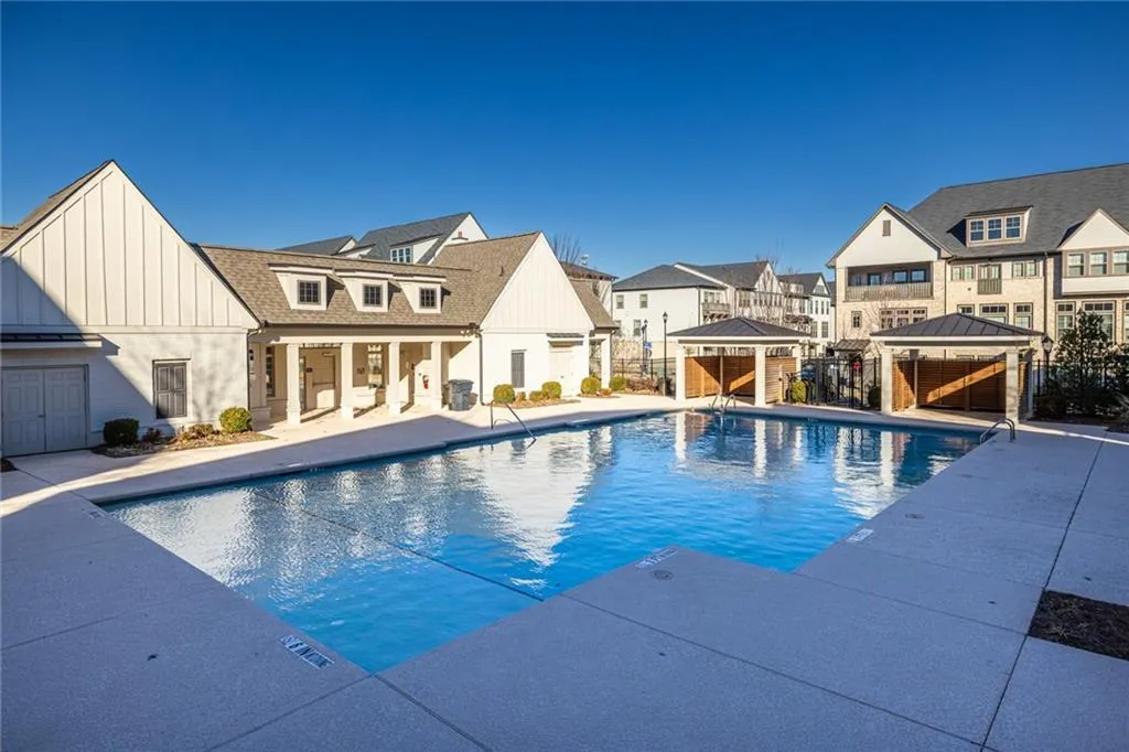 Community pool featuring a gazebo, a residential view, and a patio
