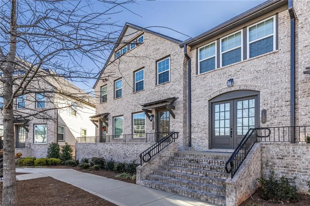 View of front of house with french doors and brick siding