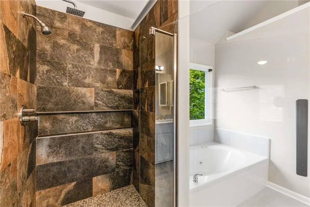 Full bathroom with a shower stall and a bath