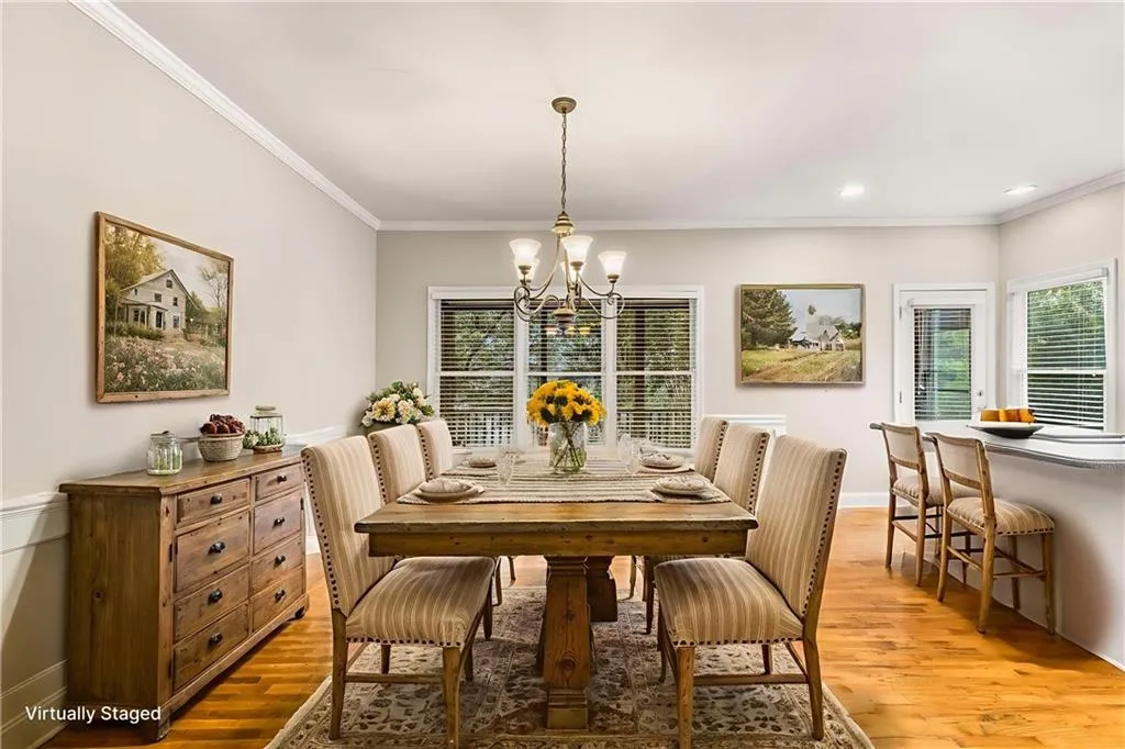 Dining space with light wood-style floors, ornamental molding, a chandelier, and recessed lighting
