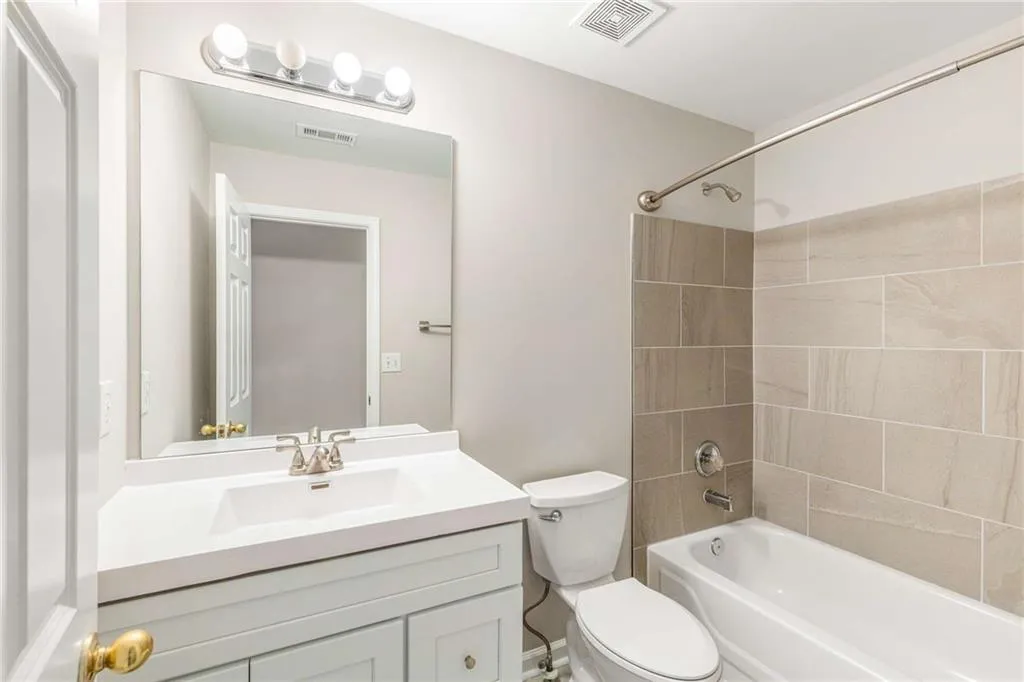 Full bath featuring  shower combination and vanity
