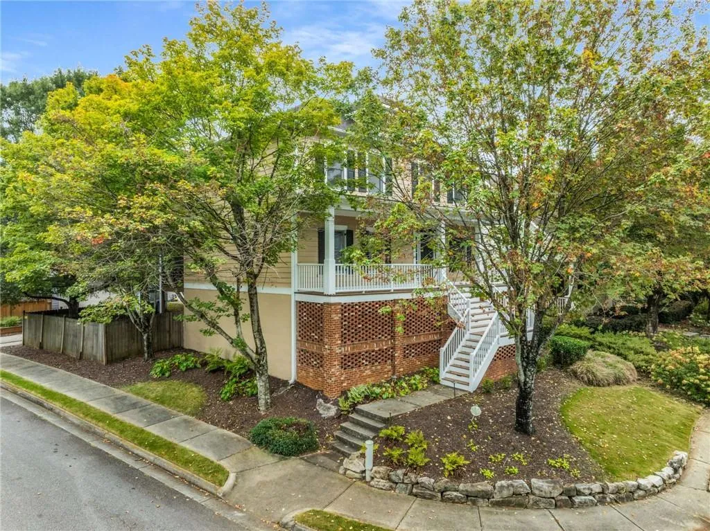 View of front of property with stairs, brick siding, and covered porch