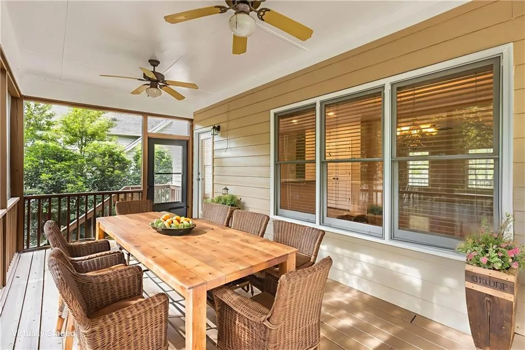 Sunroom / solarium with outdoor dining space, a ceiling fan, and a wooden deck
