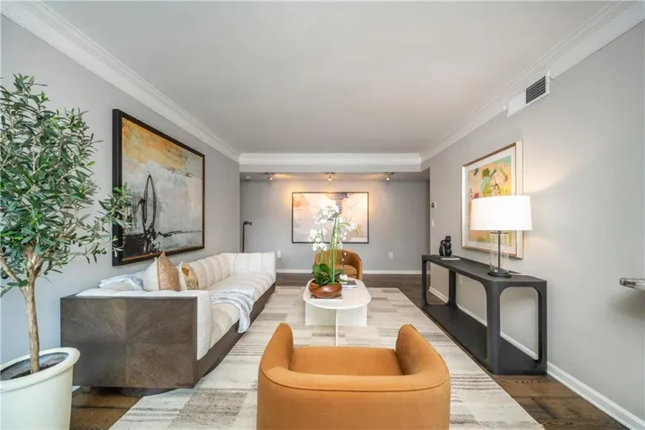 Hardwood flooring, crown molding, recessed lighting, and tray ceiling