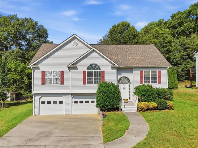 Light-colored siding exterior with a shingle roof and red shutters