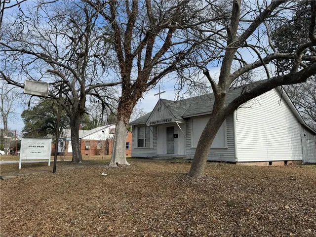 View of front of property with a shingled roof and crawl space